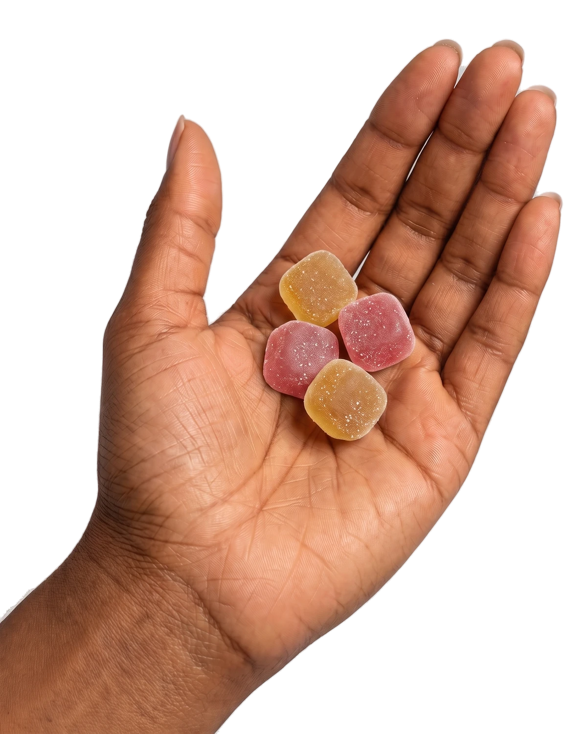An open palm holding four gummies.