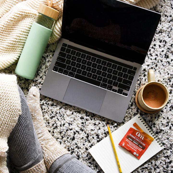 Woman on laptop searches for where to buy mushroom powder online.