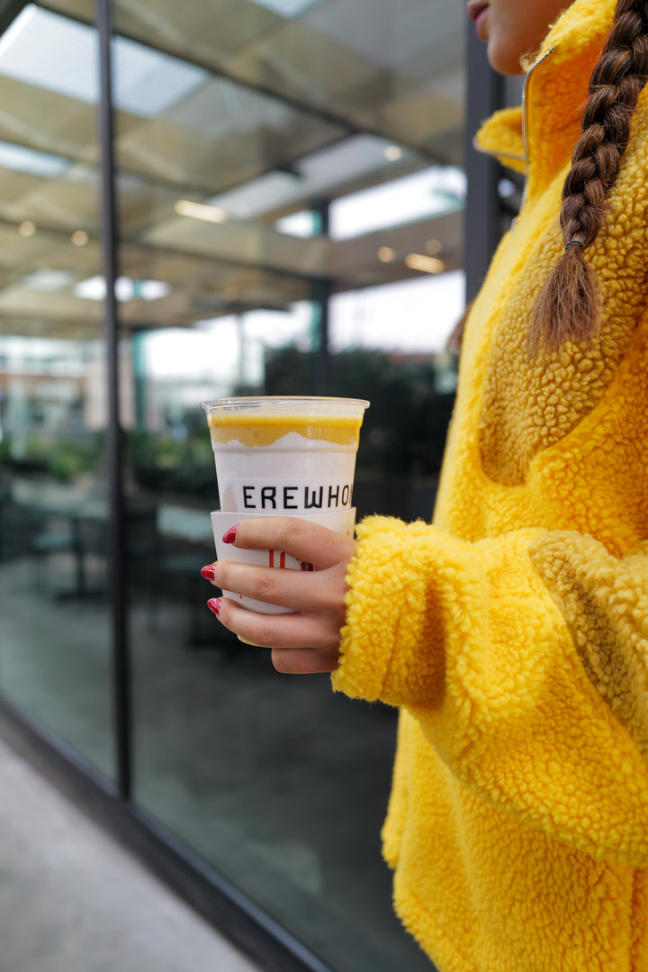 Hand holding cup of new Bella Hadid Erewhon smoothie