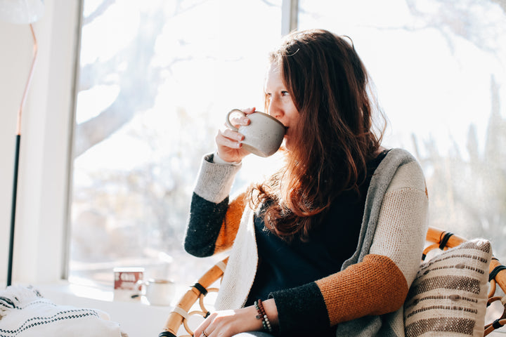 Woman drinking a mushroom coffee alternative beverage.