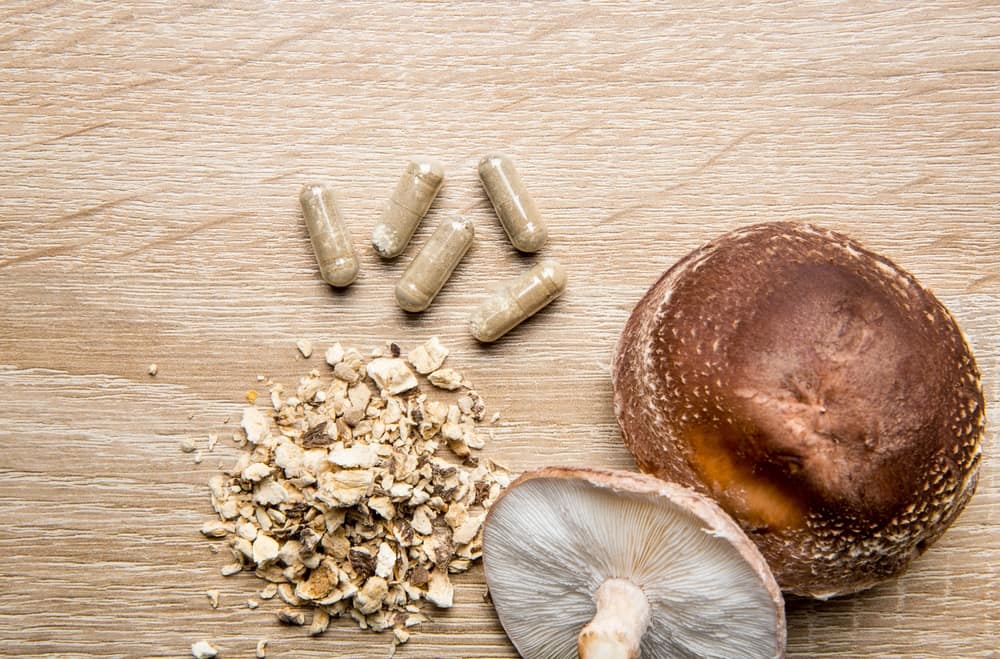 Shiitake mushrooms and biohacking supplements on wooden table