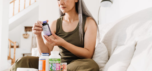 Woman on couch considering best natural supplements to take for overall health.