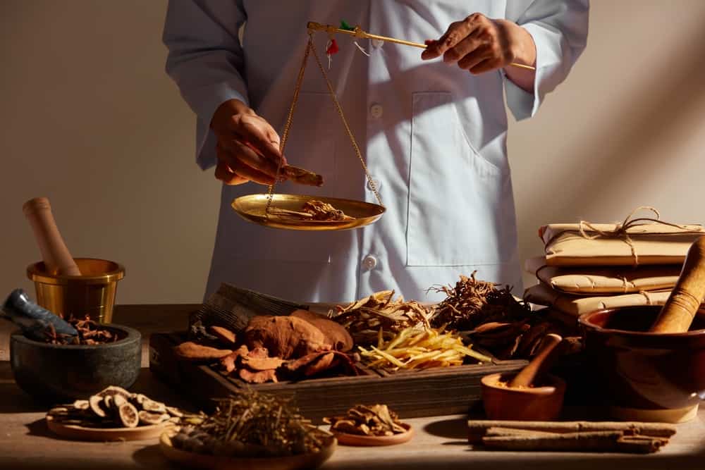 Man weighing best mushroom for hormone balance on a scale.