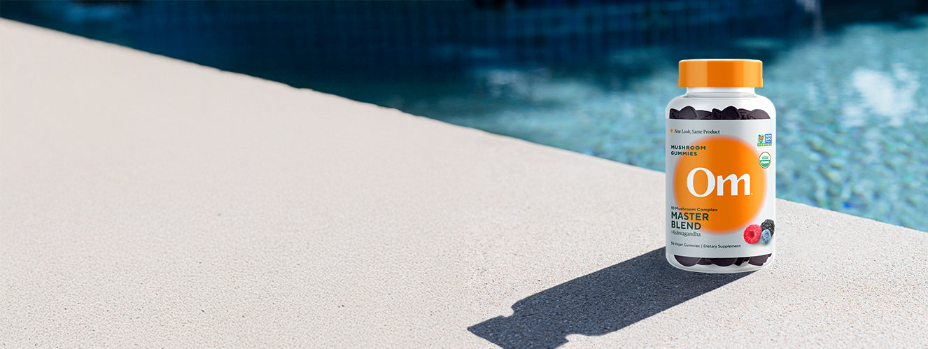 Master blend gummies bottle on a poolside ledge
