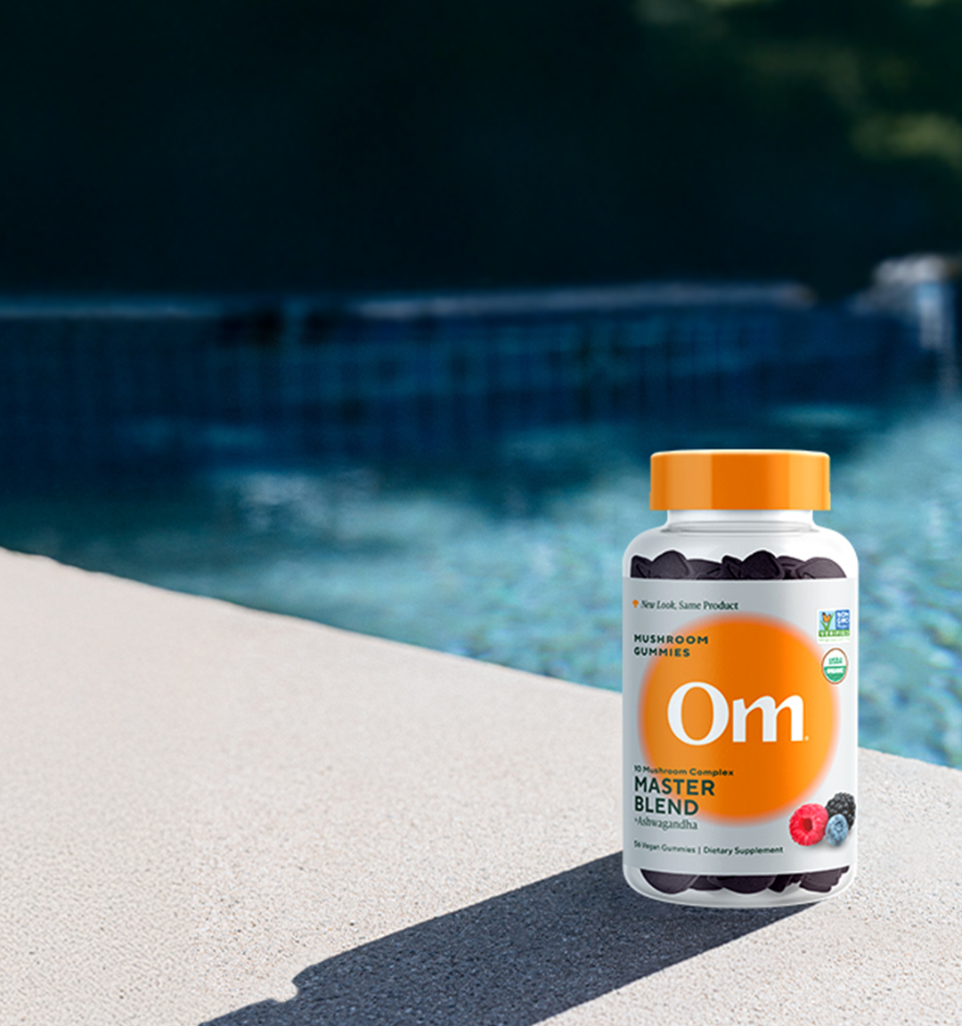 Master blend gummies bottle on a poolside ledge
