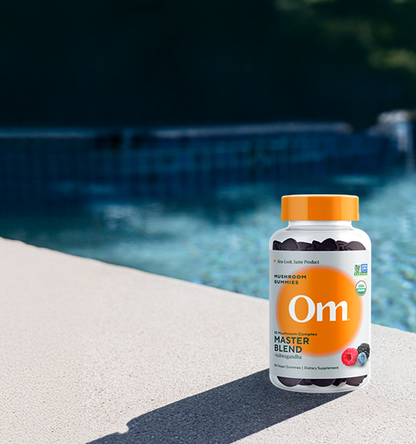 Master blend gummies bottle on a poolside ledge