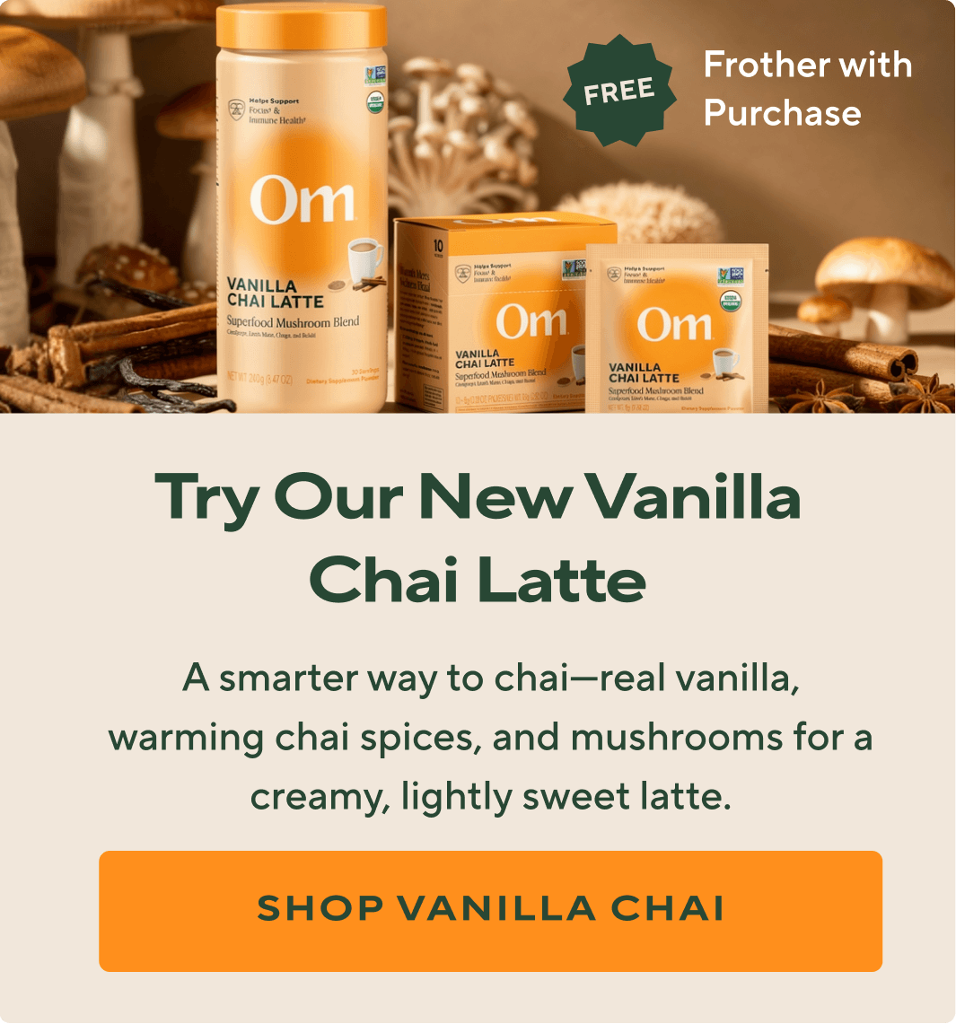 Om Mushroom Vanilla Chai Latte canister, box, and single-serve packet displayed with mushrooms, cinnamon sticks, and spices in the background