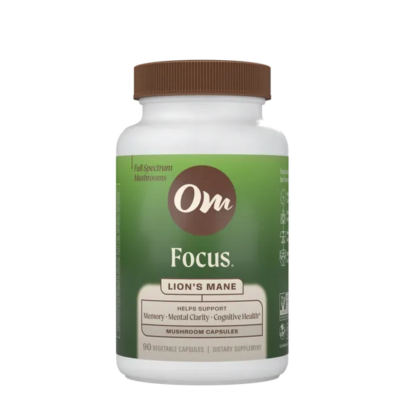 Om Focus Lion’s Mane capsules in front of a Lion’s Mane mushroom