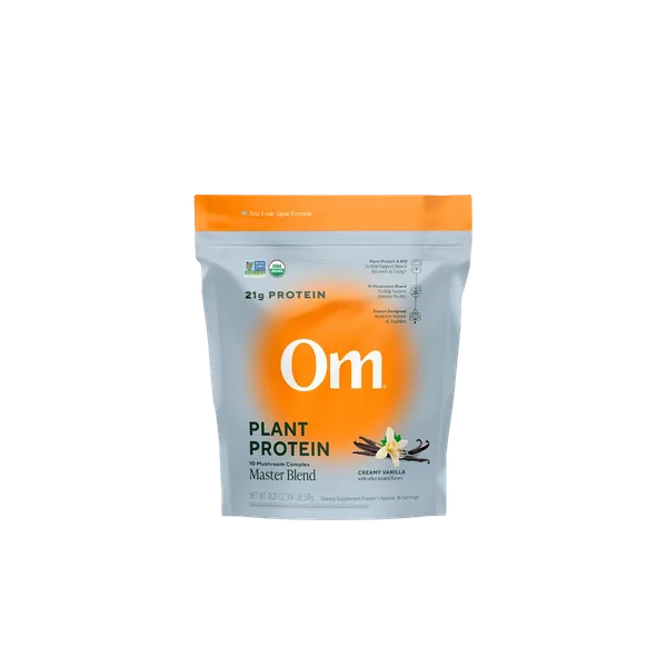 Om Master Blend Plant Protein Creamy Vanilla pouch in front of a Chaga mushroom